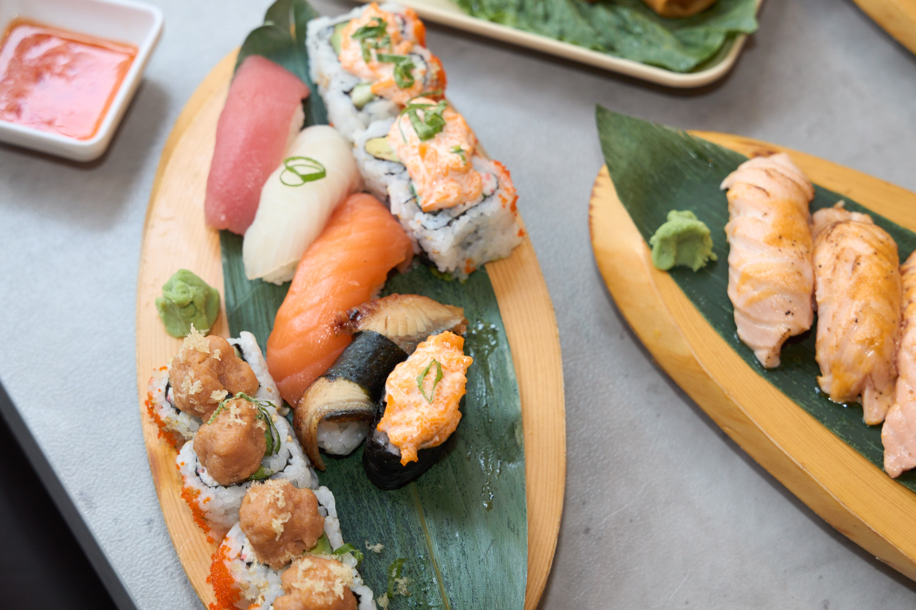 Mixed combo platter with tuna and salmon nigiri, specialty rolls on wood boat