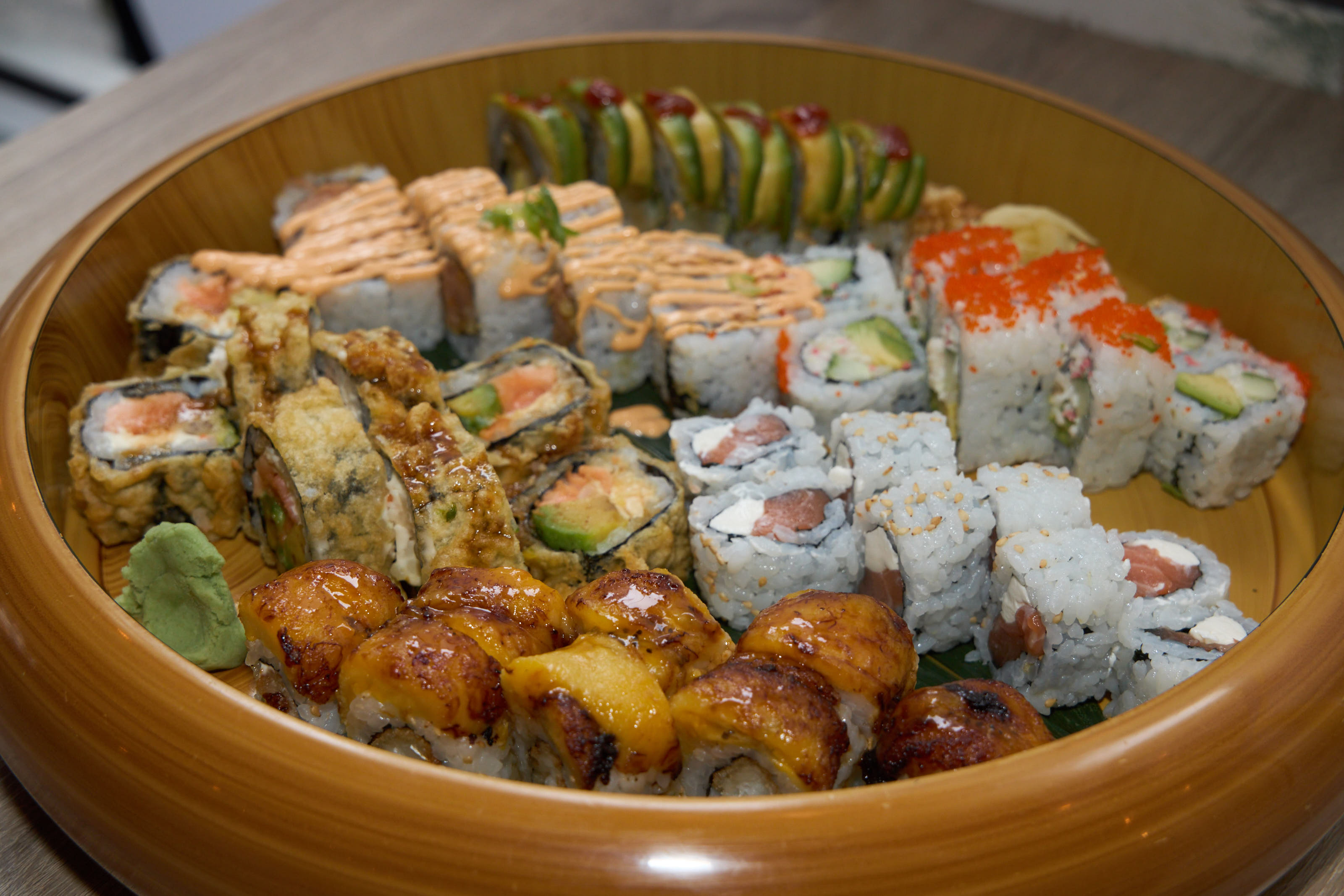 Family style assorted rolls in a large round wooden bowl