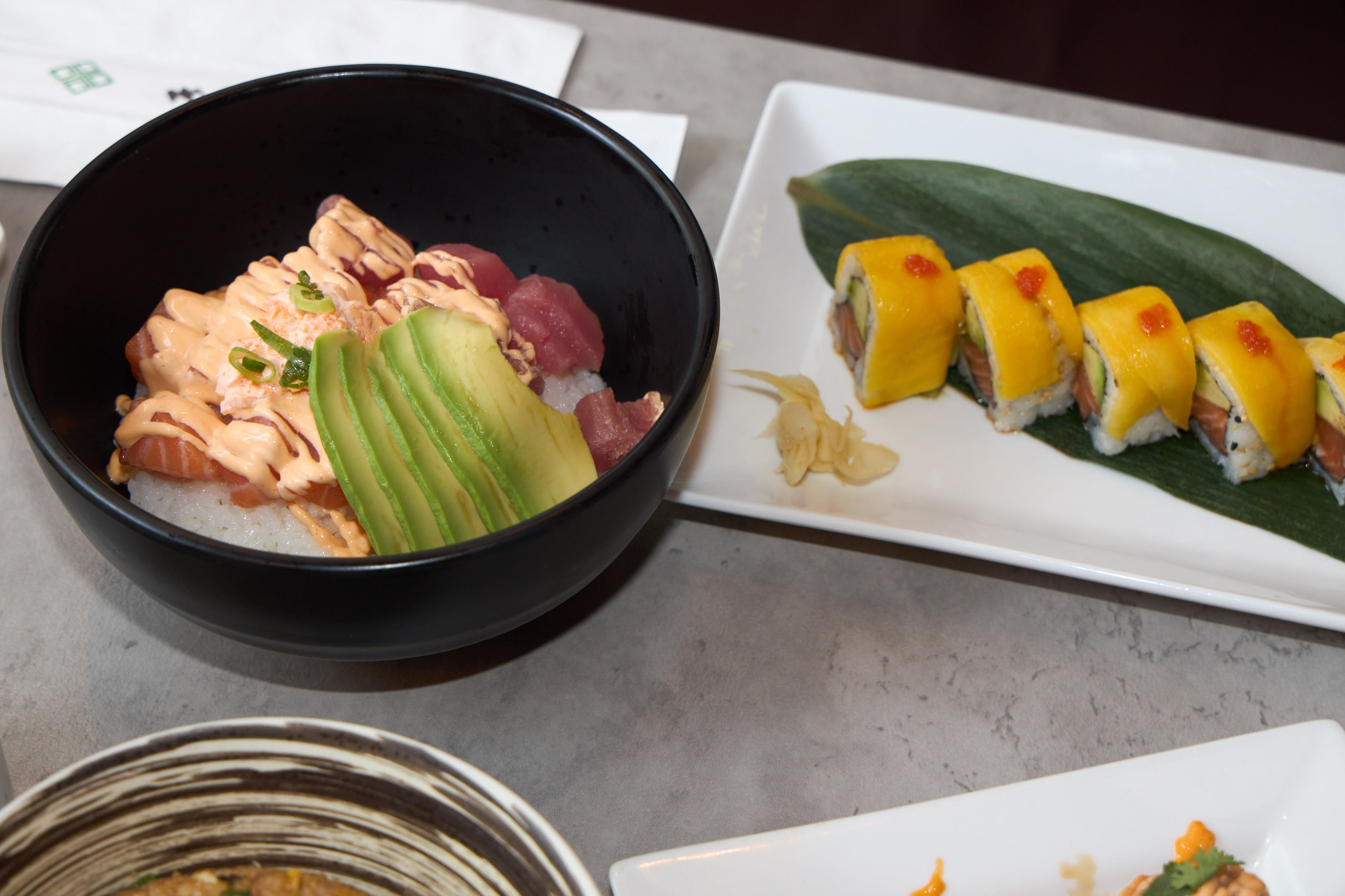 Poke bowl with salmon, avocado and mango roll